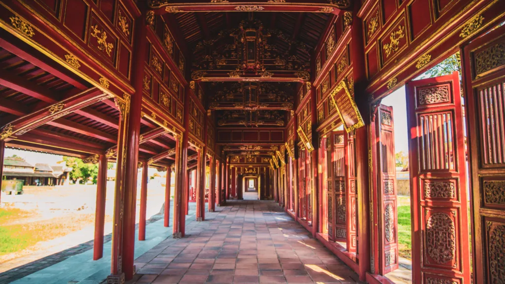 Galería con columnas rojas y detalles dorados en la Ciudad Imperial de Hue, Vietnam